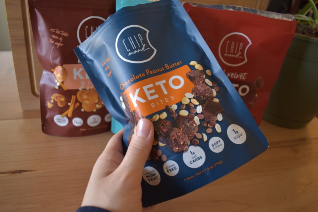 Hand holding a pack of Chip Monk Keto Cookie Bites
