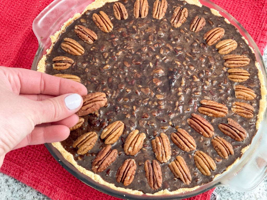 topping keto chocolate fudge pecan pie with pecans