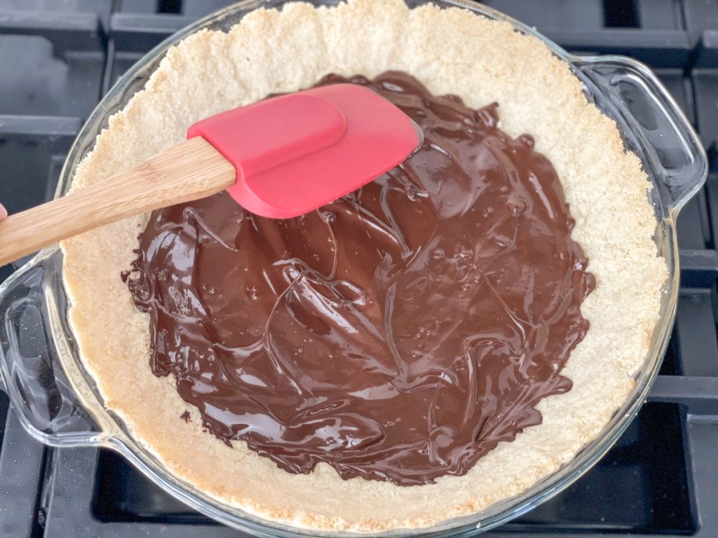 melted chocolate chips on a keto pie crust