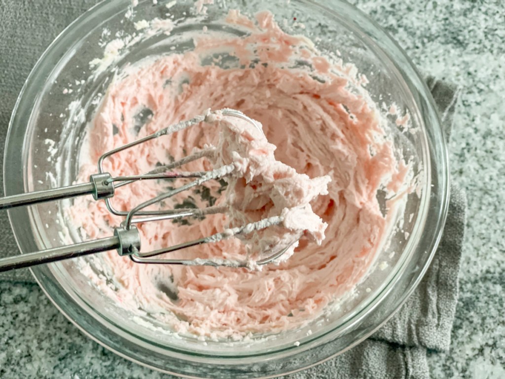 pink frosting in mixing bowl