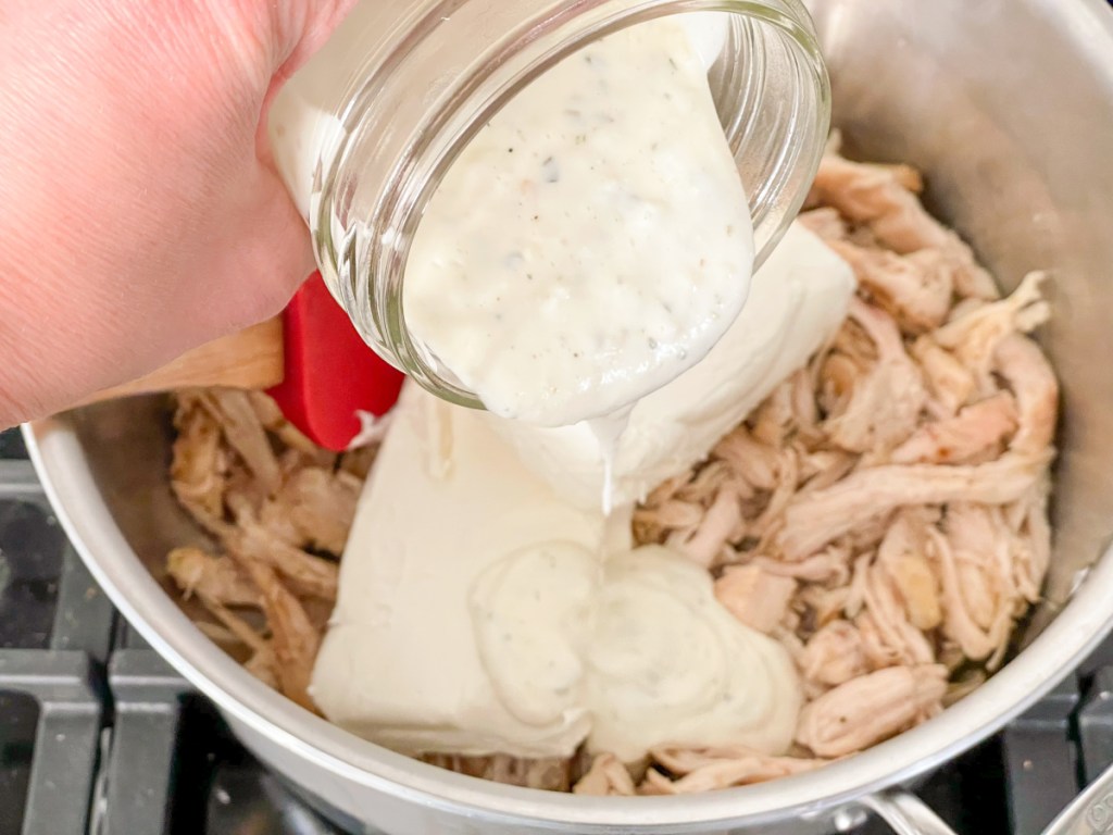 adding ranch to shredded chicken