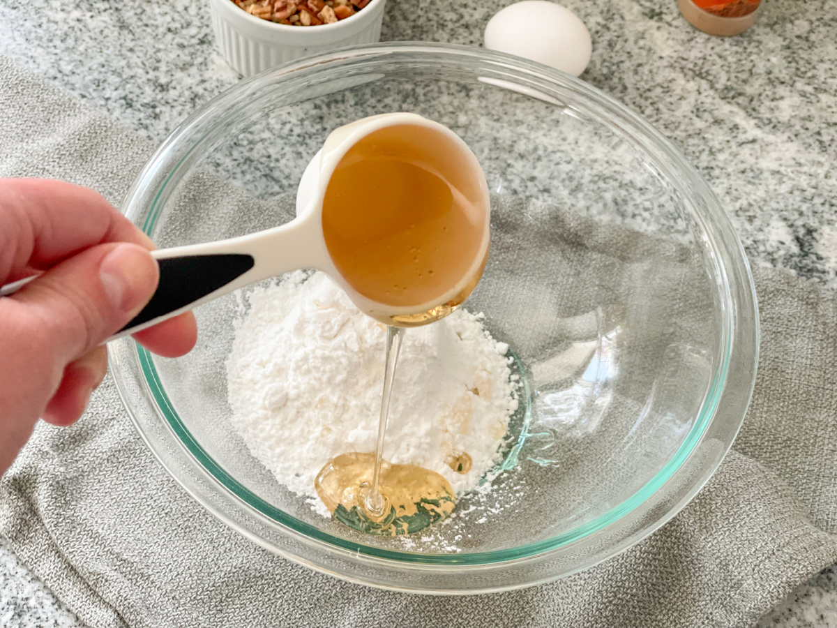 adding ChocZero Keto Honey to keto confectioners sweetener in a bowl
