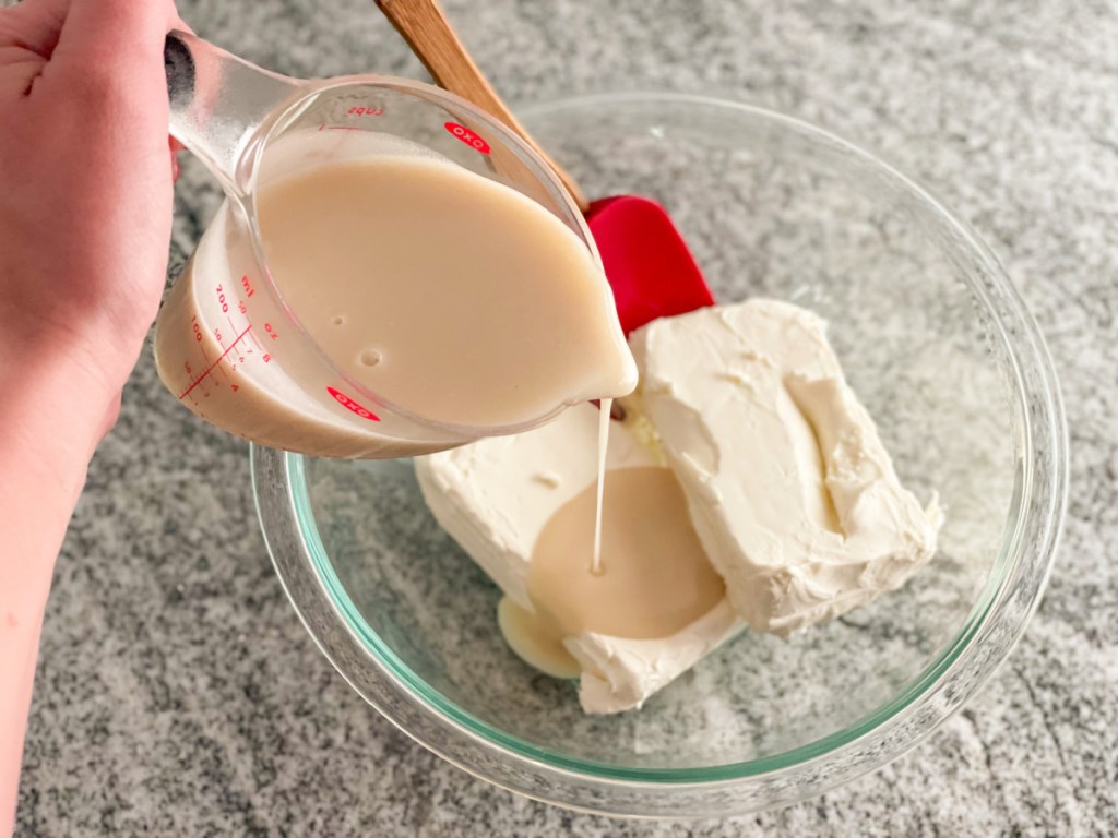 adding keto sweetened condensed milk to cream cheese
