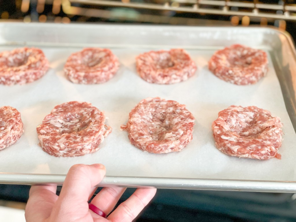 putting sausage patties into the oven