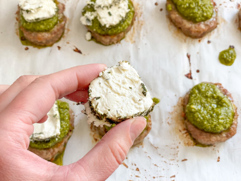 adding goat cheese to sausage patties