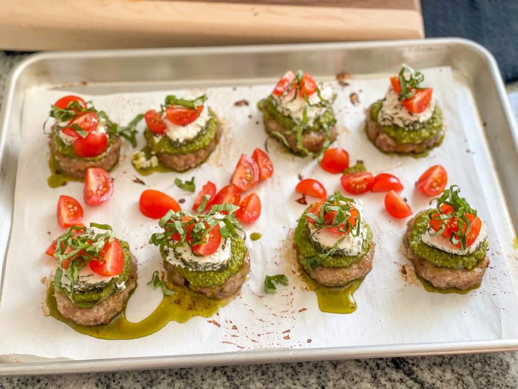 sausage patties with pesto, goat cheese, tomatoes 