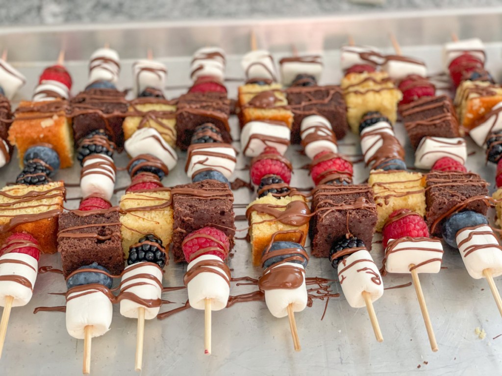 dessert kabobs with chocolate drizzled on them