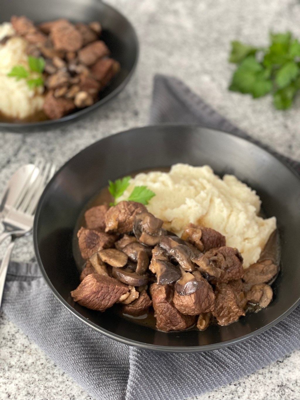 beef tips plated with mashed cauliflower 
