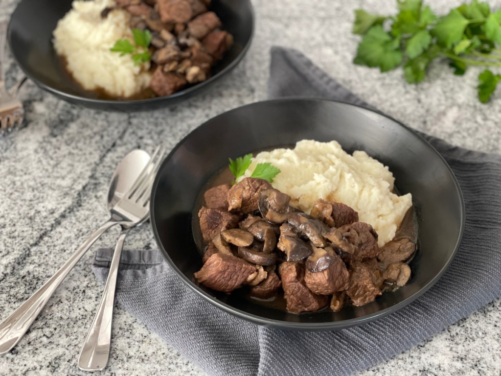 beef tips plated with mashed cauliflower 