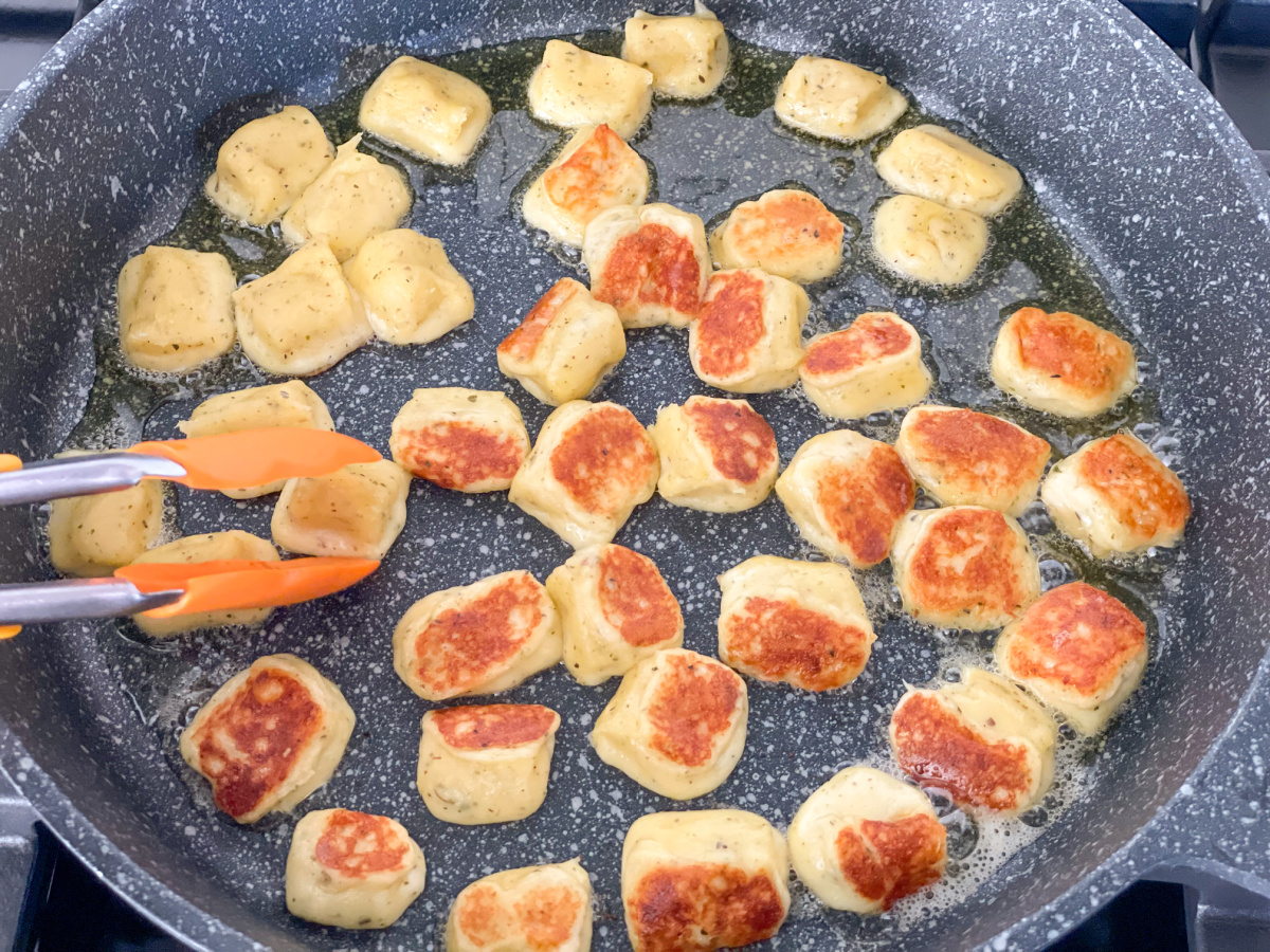 flipping over keto gnocchi recipe in a skillet