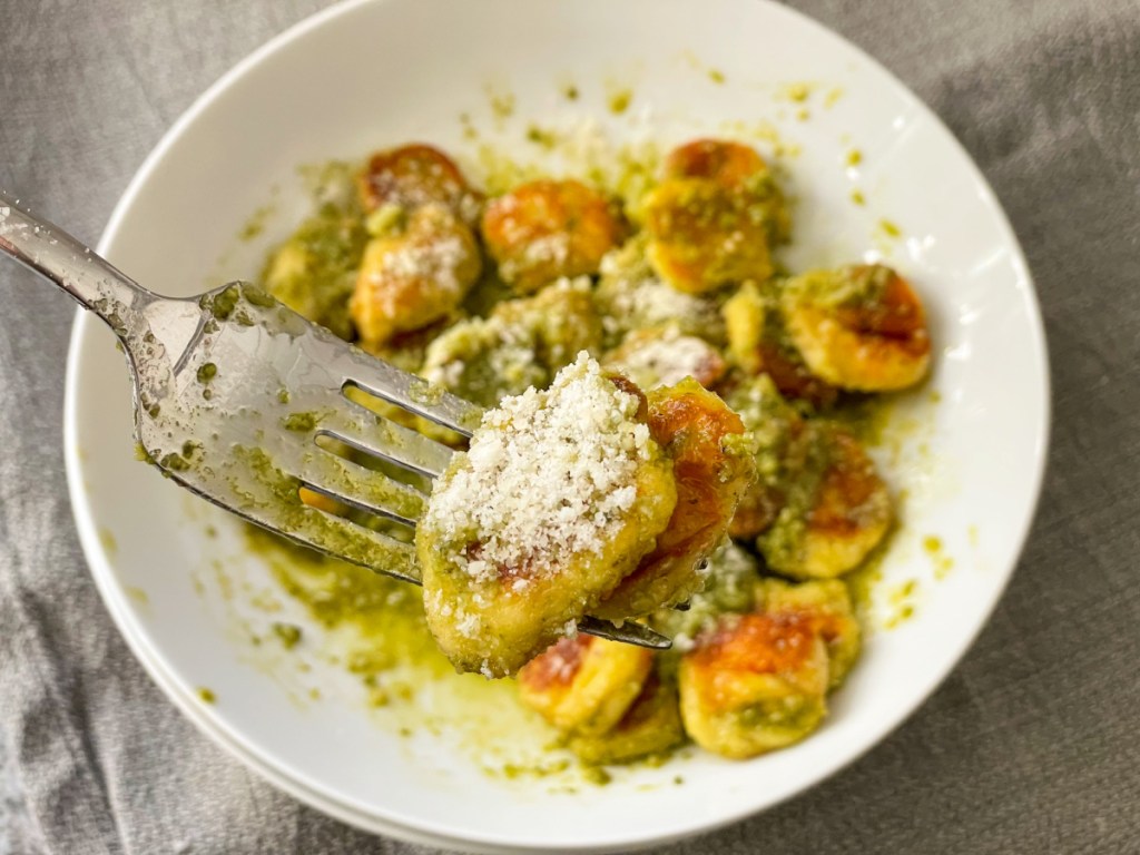 bite of keto gnocchi on a fork with pesto and part
