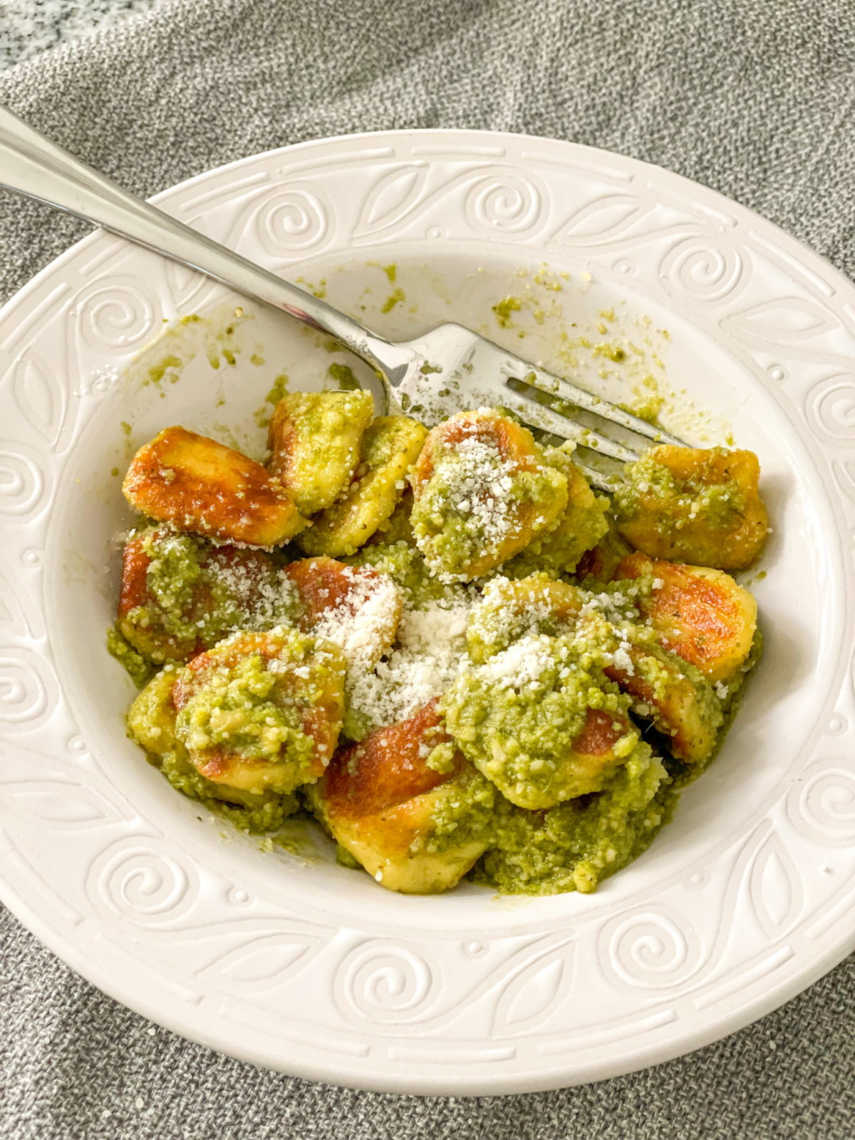keto gnocchi recipe in a bowl with pesto and parmesan