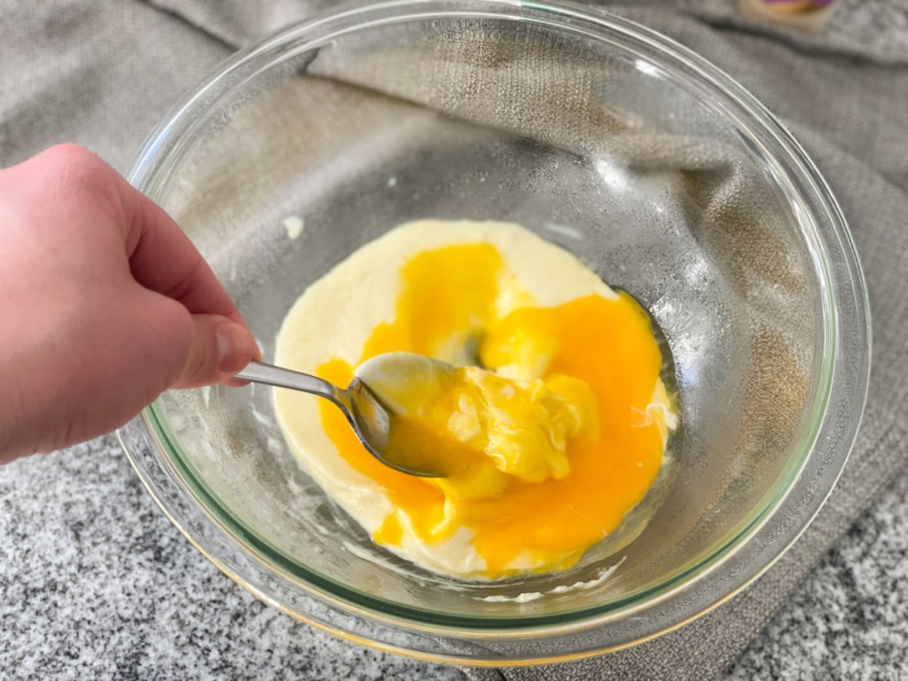 melted mozzarella cheese in a bowl with egg yolks