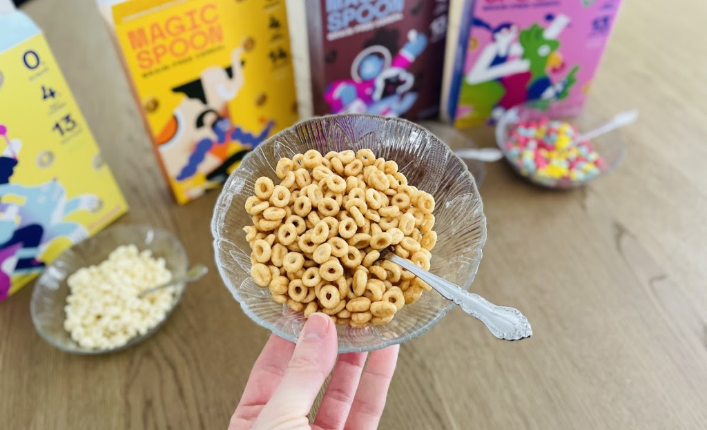 Hand holding a bowl of low carb Magic Spoon Cereal