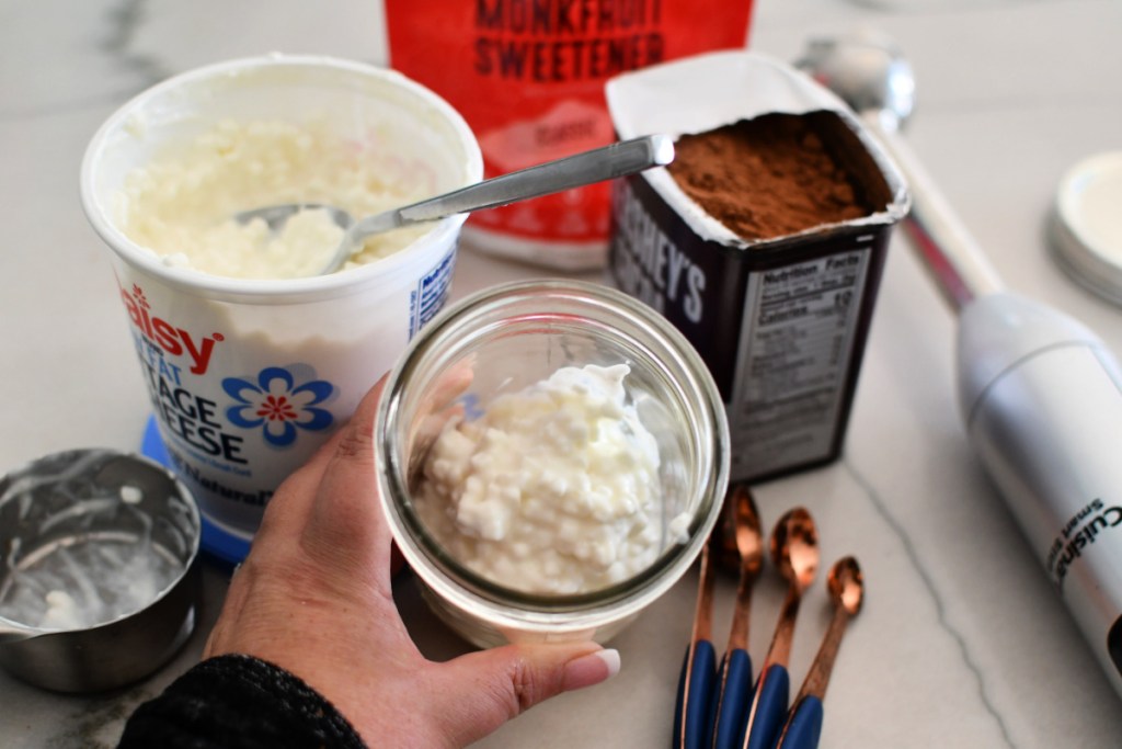 adding cottage cheese to a jar
