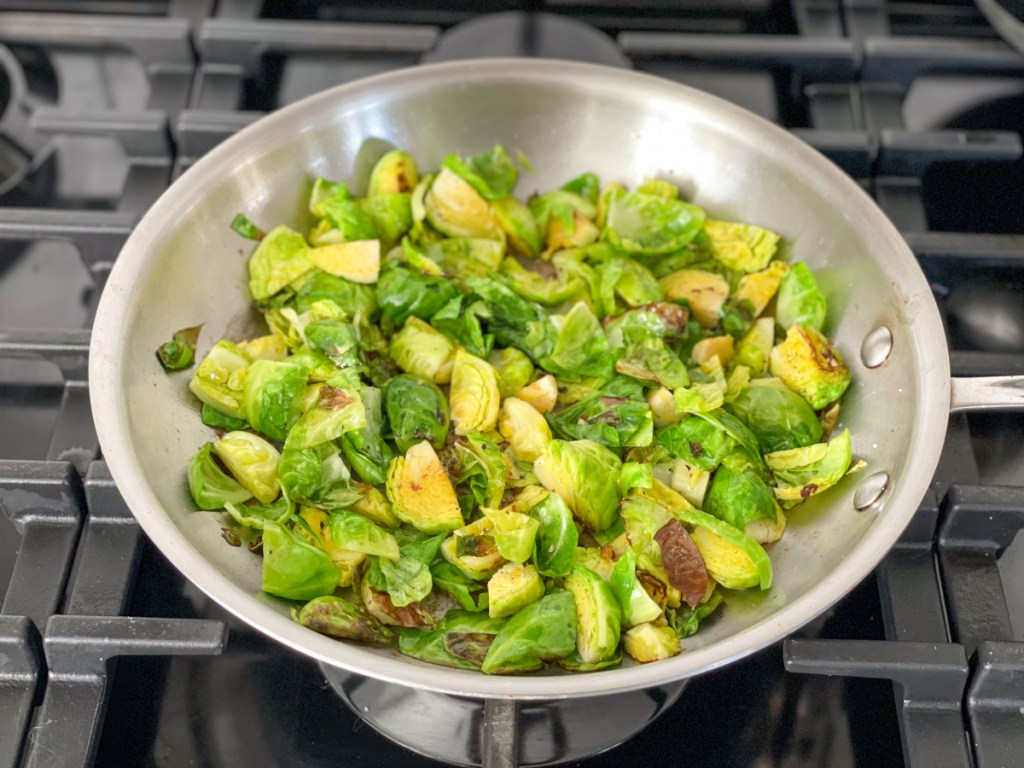 cooking Brussels sprouts in a skillet in duck fat