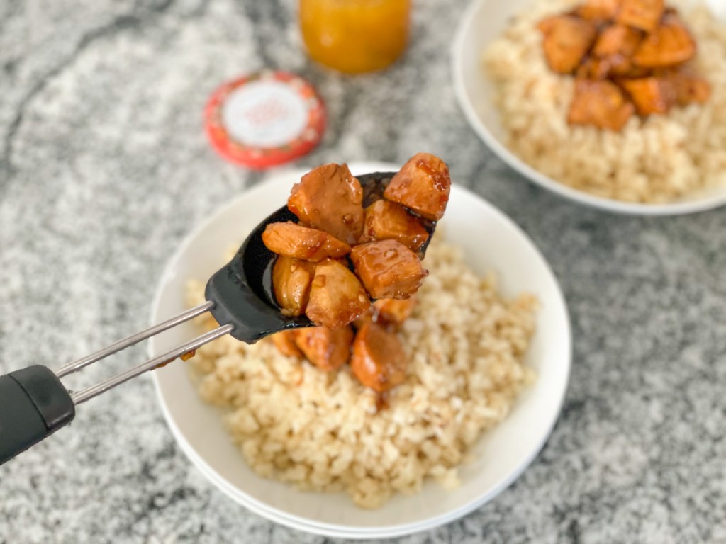 dishing up keto orange chicken over cauliflower rice