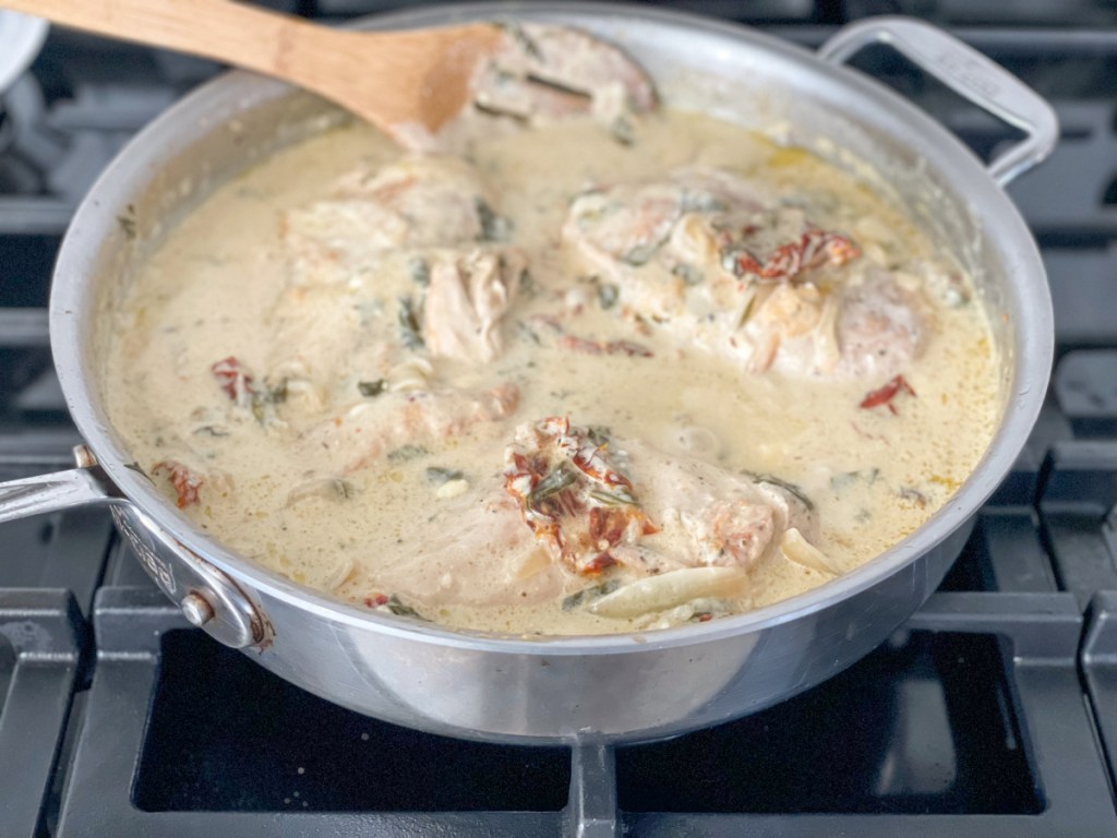 simmering tuscan chicken on the stovetop