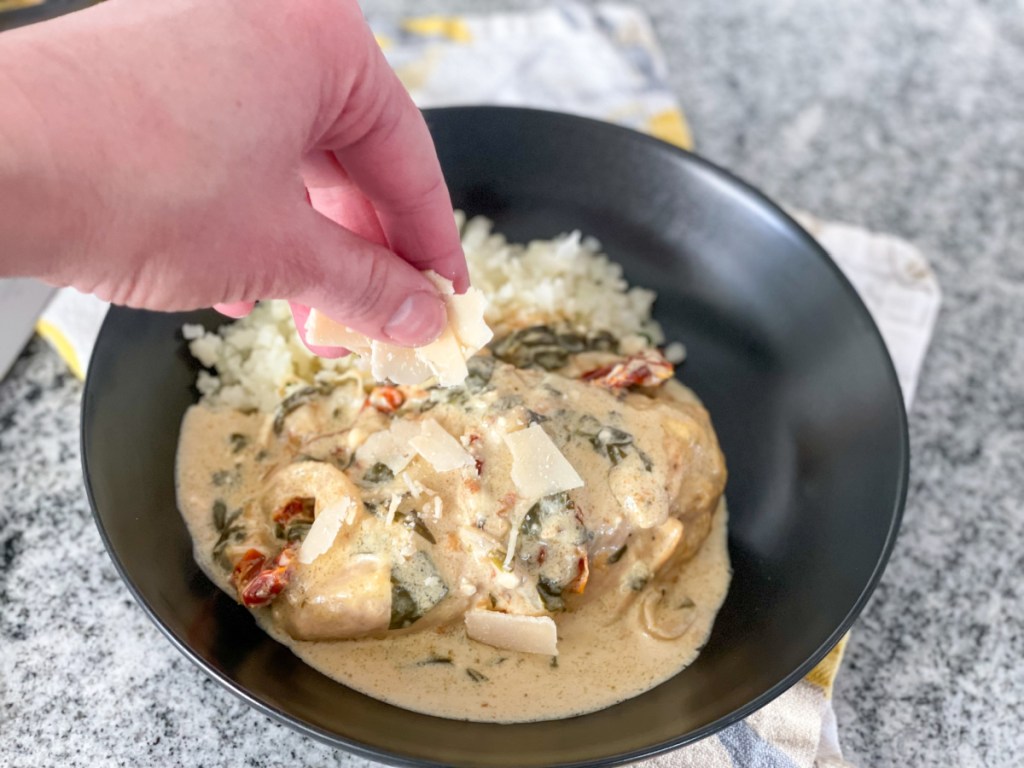 adding shaved parmesan to tuscan chicken 