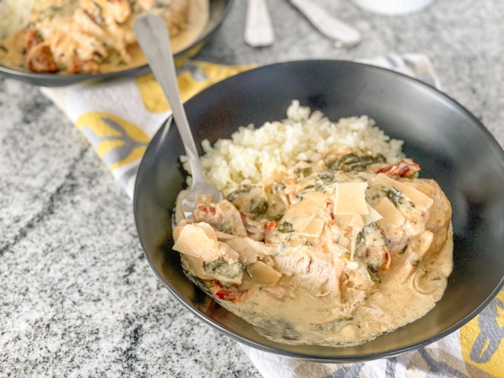 tuscan chicken with a bite on a fork 