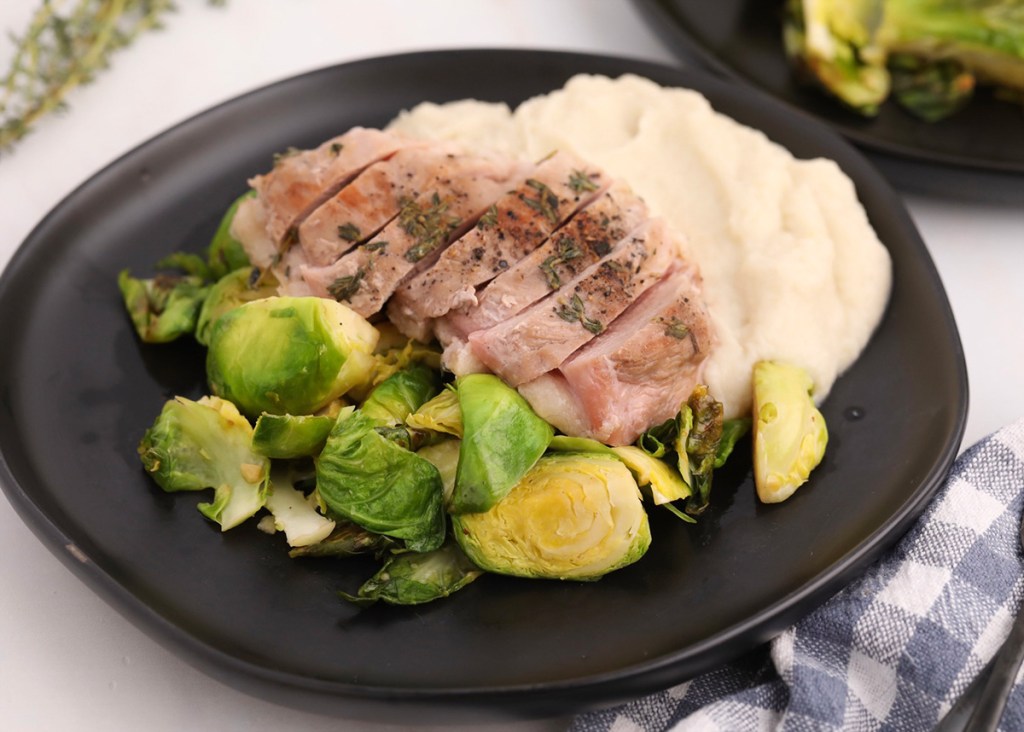 keto duck breast, Brussels sprouts, and mashed cauliflower on plate