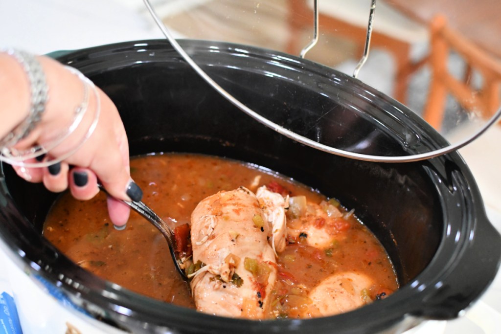 slow cooker with chicken inside to shred