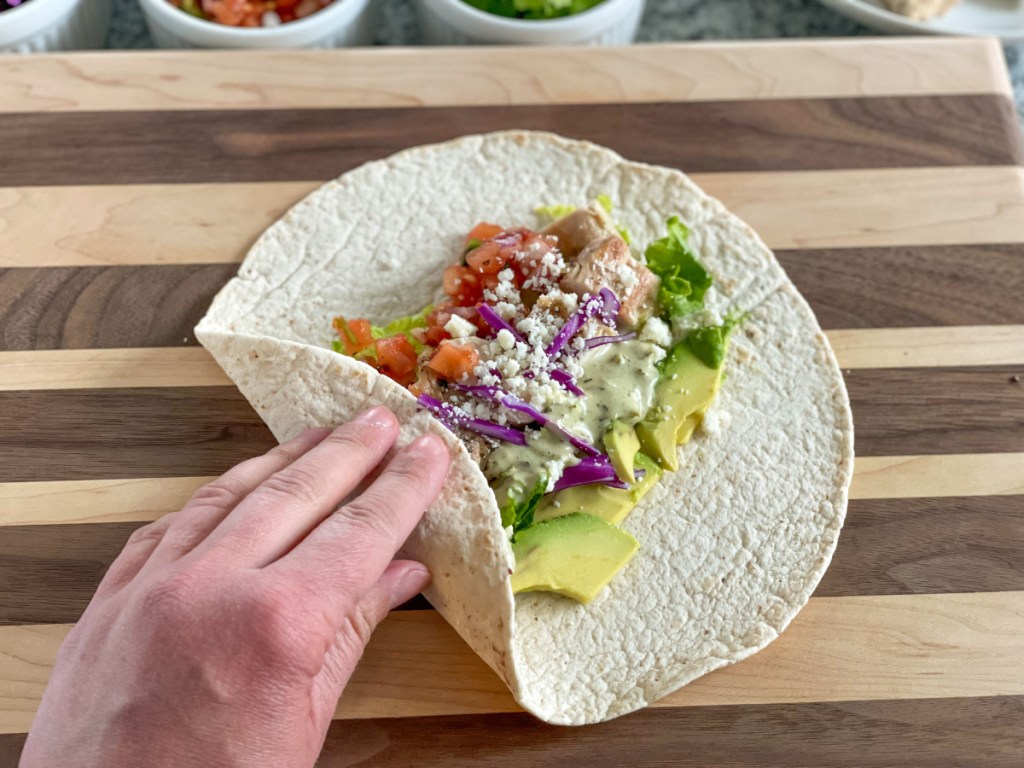 folding a keto tortilla into a keto burrito