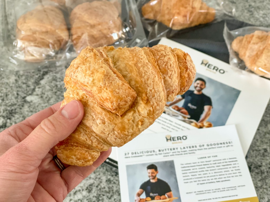 holding a Hero Bread Croissant