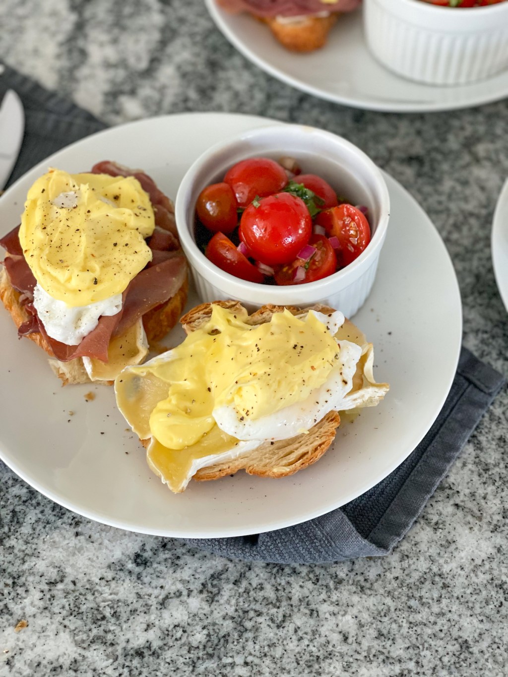 keto eggs benedict plated with a tomato salad