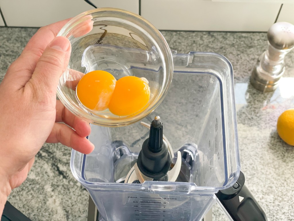 putting two egg yolks into a blender