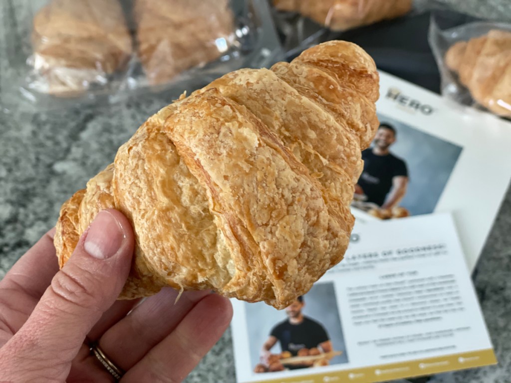 Hand holding a Hero Bread keto croissant