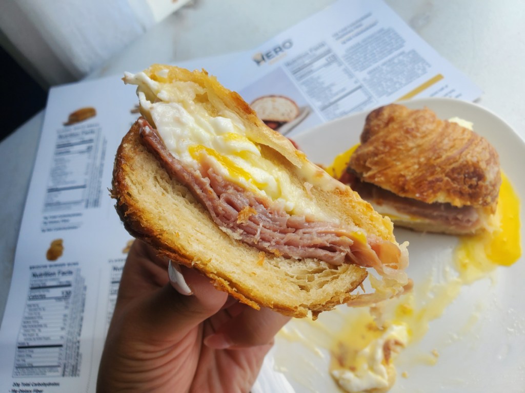 Hero croissant used as bun for an eggs benedict sandwich