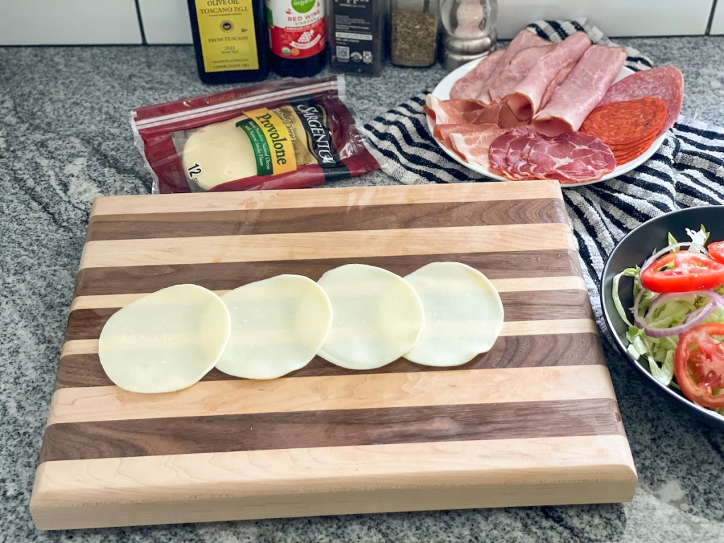 provolone slices on a cutting board
