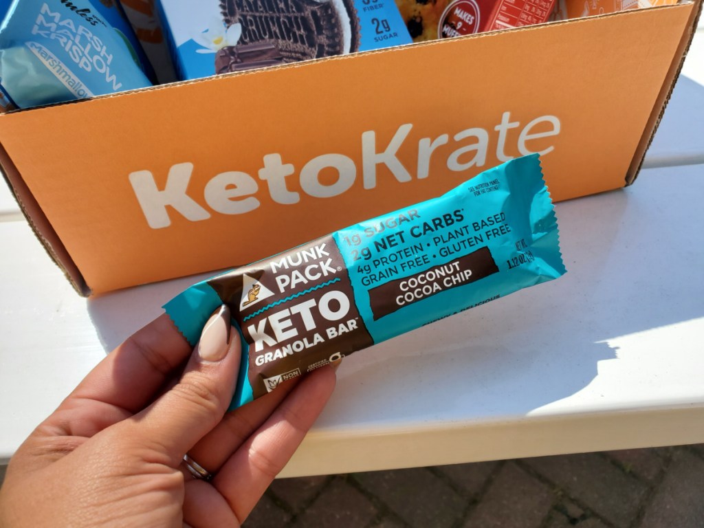 Hand holding a Munk Pack Keto Granola Bar from their keto krate