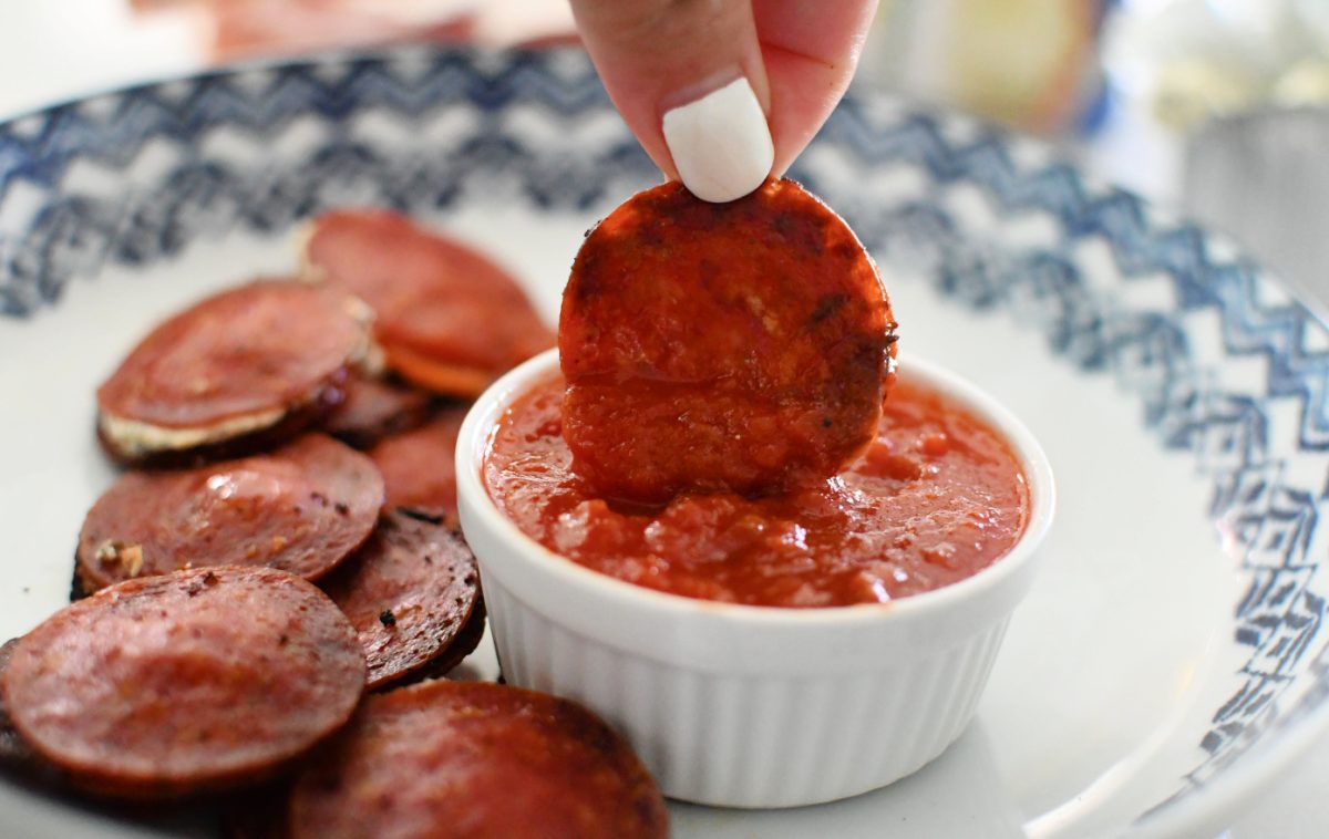 dipping pepperoni bites into marinara