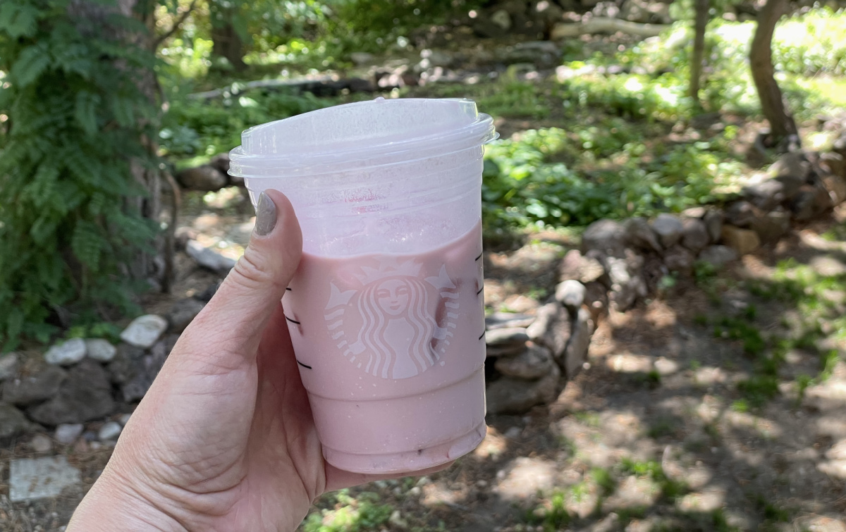 hand holding up a keto pink drink copycat