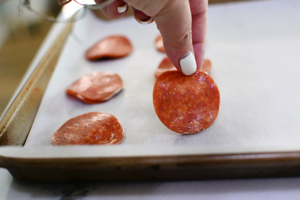 placing pepperoni bites on a sheet pan