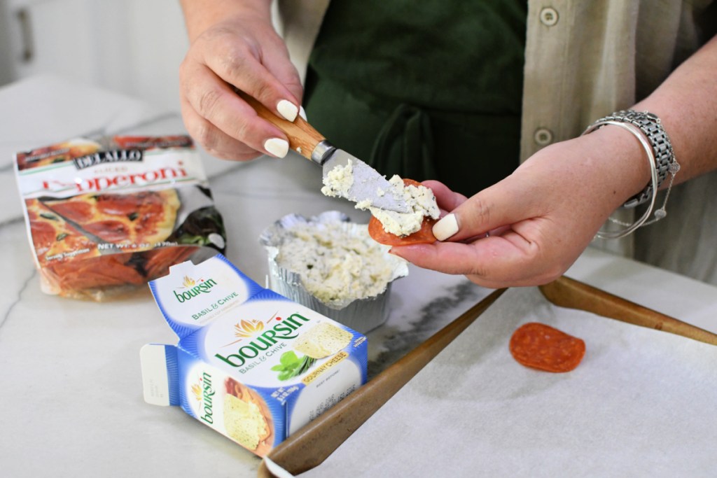woman spreading boursin cheese