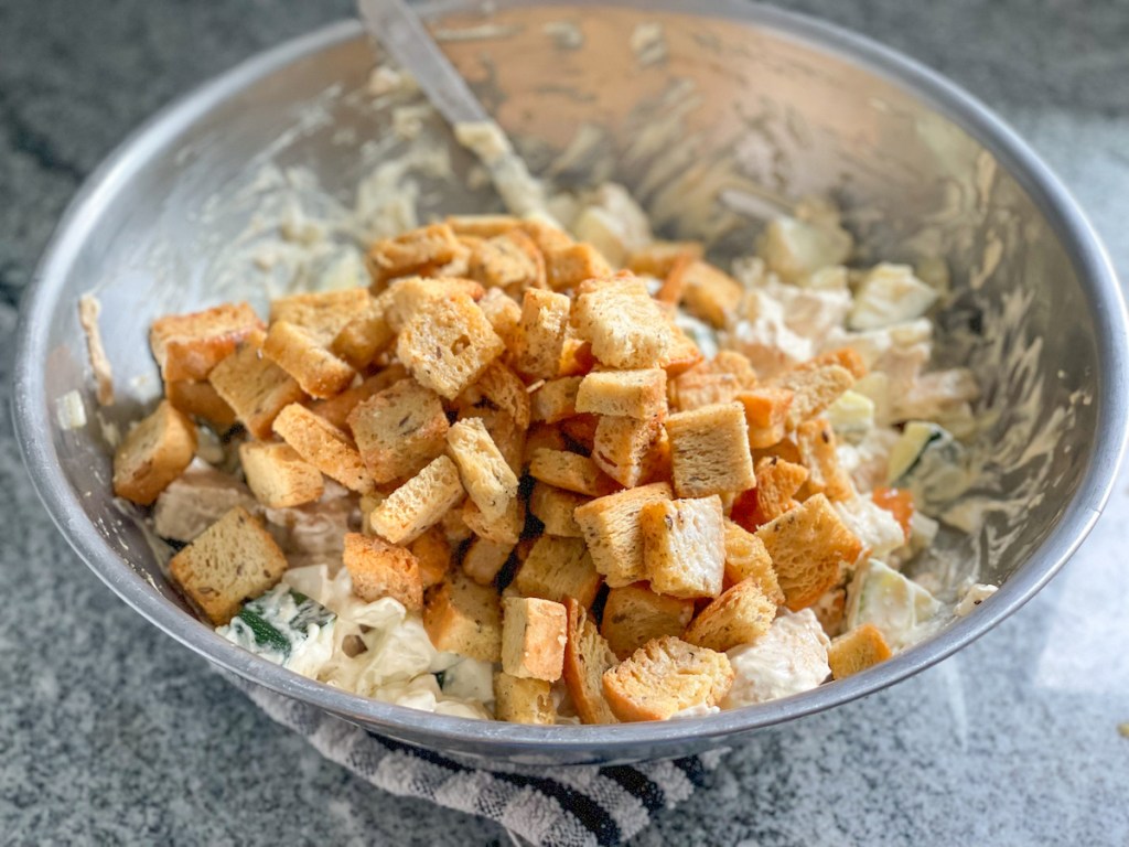 bowl with keto croutons, chopped chicken, zucchini, and onion