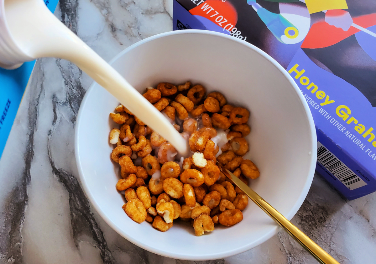 pouring milk into bowl of magic spoon honey graham cereal