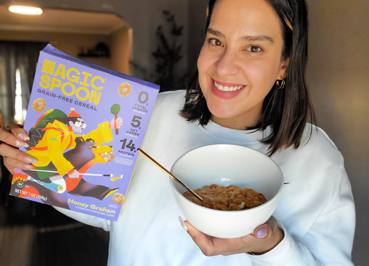 woman holding a bowl and box of keto cereal from magic spoon