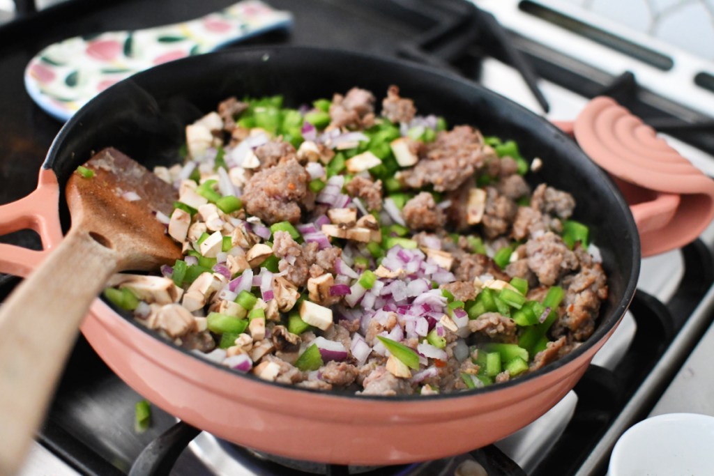 chopped veggies and ground sausage in a skillet