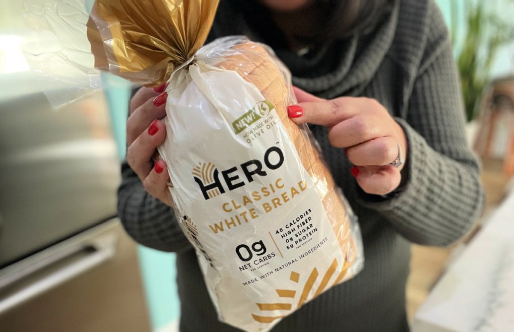 woman holding up a bag of keto HERO bread made with olive oil