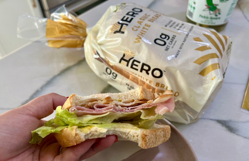 hand holding a low carb sandwich made from the new hero bread made with olive oil