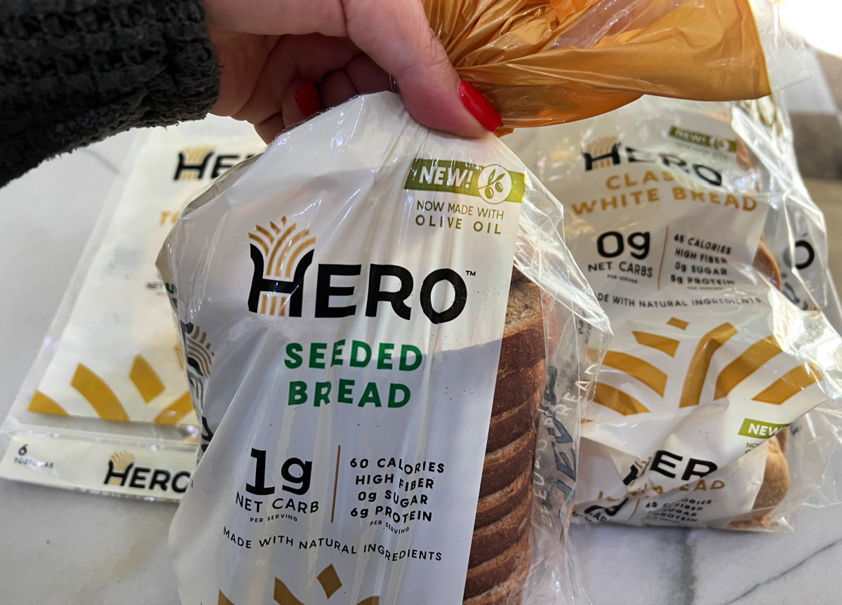 Hand holding up a loaf of keto hero bread