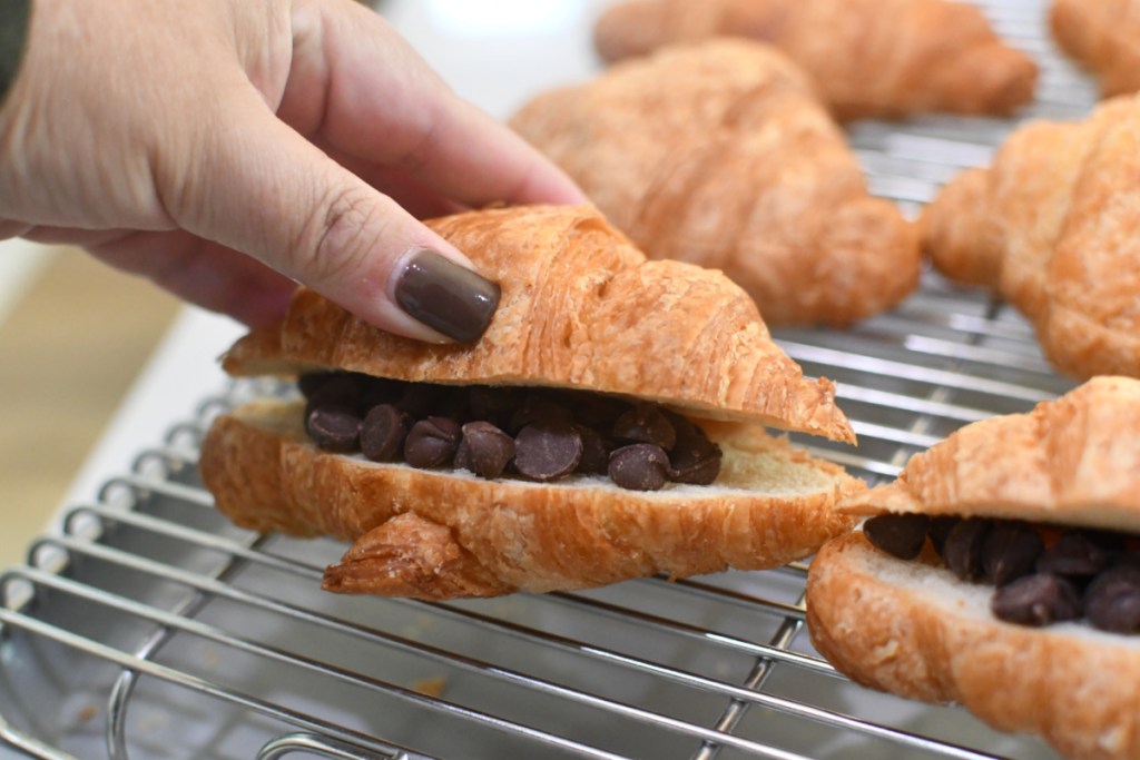 adding chocolate chips to the middle of croissants