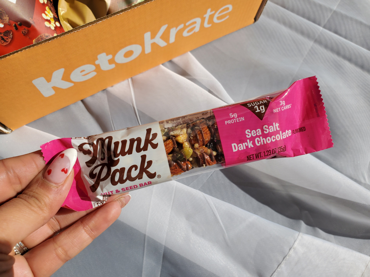 Hand holding a Munk Pack Nut and Seed Bar 