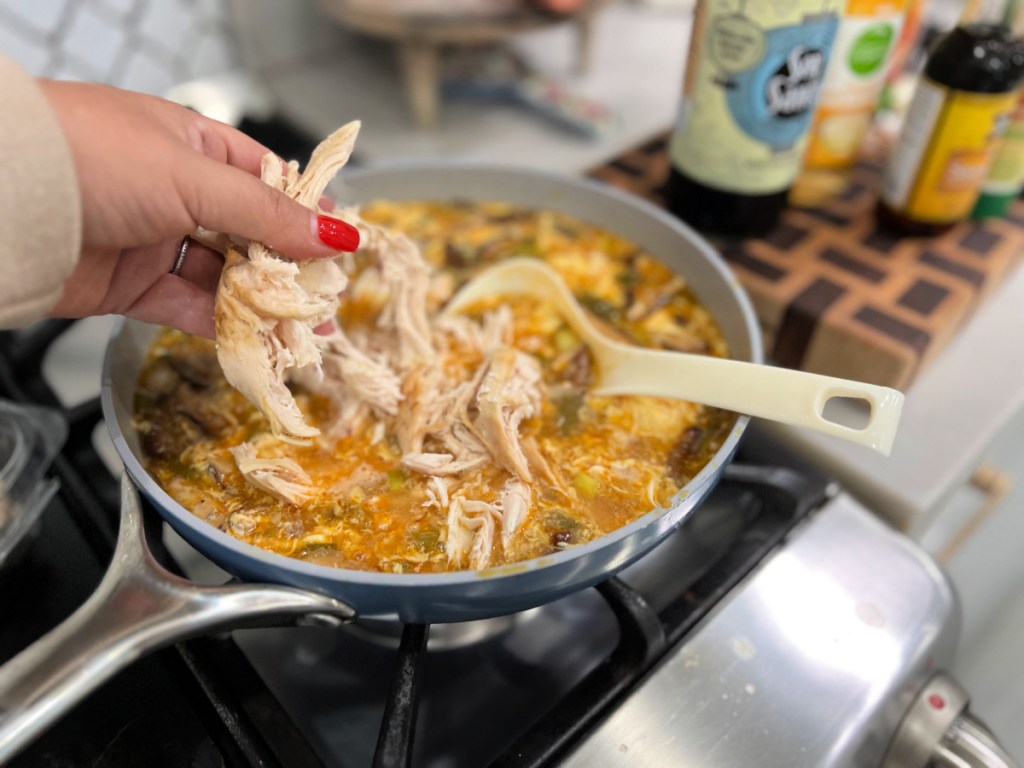 adding chicken to hot and sour soup