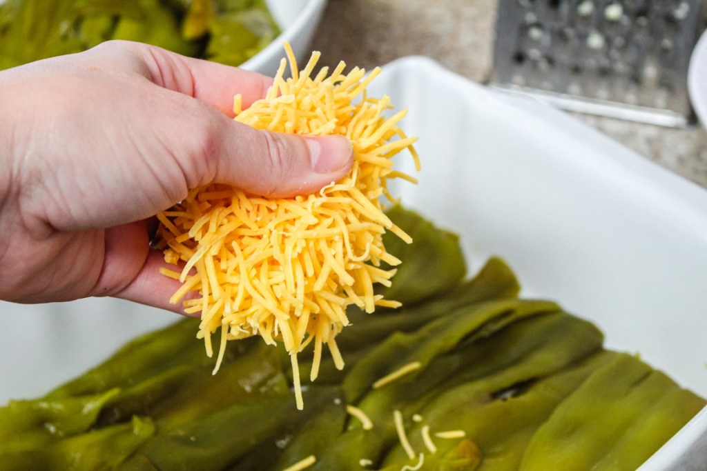 Adding cheese over green chiles