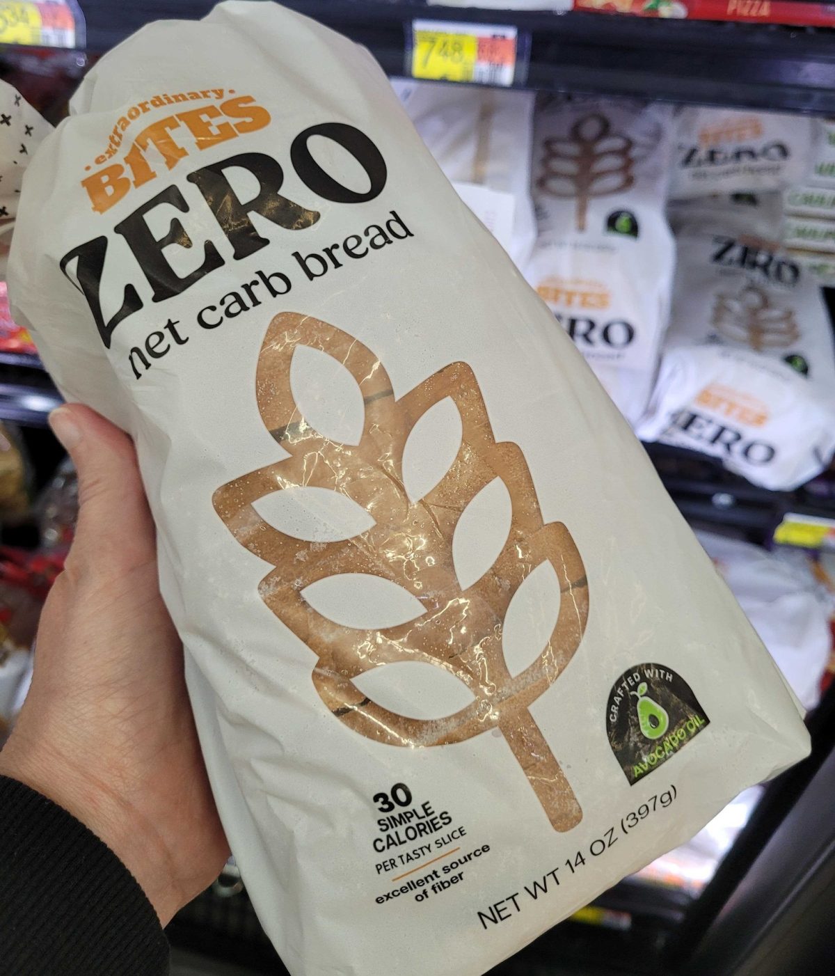 Hand holding Extraordinary Bites Zero Carb Bread at Walmart